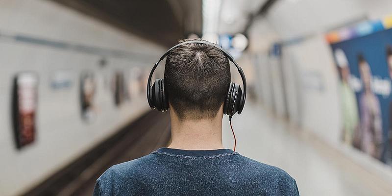Man wearing headphones in the subway