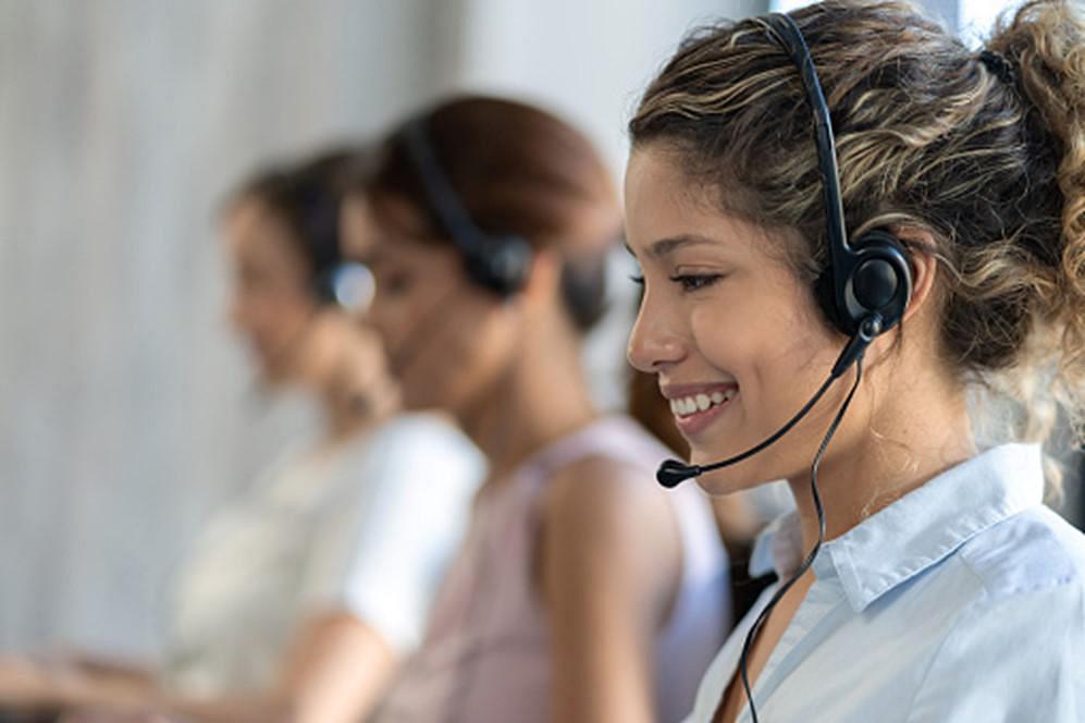 people in a call centre with headsets on