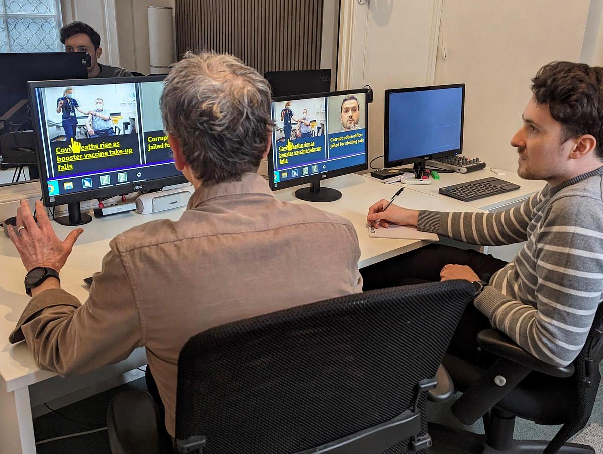 Moderator sitting with a Disabled User carrying out User Testing