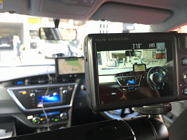 Camera screen showing steering wheel and sat nav